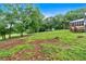 Expansive green yard with mature trees, outbuildings and lush surroundings create a private outdoor oasis at 85 Carroll Slough Rd, Kingston, GA 30145