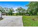 Long driveway leads to the side of the home and detached shed, surrounded by lush greenery at 85 Carroll Slough Rd, Kingston, GA 30145
