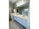Large bathroom with double vanity, shower with gold trim, and window overlooking tub at 2520 Legend Mill Run, Dacula, GA 30019