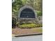 Stone community sign reads Apalachee Heritage, surrounded by colorful flowers and lush landscaping at 2520 Legend Mill Run, Dacula, GA 30019