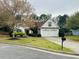 Charming single-story home featuring a two-car garage and a well-manicured front yard with mature landscaping at 2520 Legend Mill Run, Dacula, GA 30019