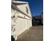 Close up of the two-car garage showcasing decorative shutters and clean white garage doors at 2520 Legend Mill Run, Dacula, GA 30019