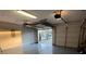 Clean and spacious garage, featuring an open garage door to the backyard and work lighting at 2520 Legend Mill Run, Dacula, GA 30019