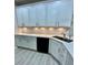 Elegant kitchen featuring white cabinets, a corner sink with modern fixtures, and ample countertop space for meal preparation at 2520 Legend Mill Run, Dacula, GA 30019