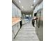 A well-lit kitchen features light gray floors, white cabinets, and stainless steel appliances at 2520 Legend Mill Run, Dacula, GA 30019