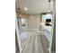 Open kitchen and dining area offers white cabinets, modern appliances, and light gray floors at 2520 Legend Mill Run, Dacula, GA 30019