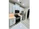 Modern kitchen features stainless steel appliances, sleek white countertops, and ample cabinet space for optimal organization at 2520 Legend Mill Run, Dacula, GA 30019