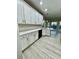 Modern kitchen showcasing white cabinetry, sleek countertops, and light wood flooring with a bright, open design at 2520 Legend Mill Run, Dacula, GA 30019