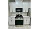 Stylish kitchen with stainless steel appliances, white cabinetry and countertops, creating a functional and modern space at 2520 Legend Mill Run, Dacula, GA 30019
