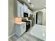 Well-lit kitchen features white cabinets, stainless steel appliances, and a black microwave at 2520 Legend Mill Run, Dacula, GA 30019