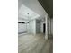 Bright, open-concept living room boasts updated flooring, a modern light fixture, and lots of natural light at 2520 Legend Mill Run, Dacula, GA 30019