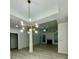 Bright, open-concept living room boasts updated flooring, a modern light fixture, and lots of natural light at 2520 Legend Mill Run, Dacula, GA 30019