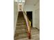 Carpeted staircase with wood railing leading to the upper level at 2520 Legend Mill Run, Dacula, GA 30019