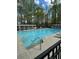 Large community swimming pool with lounge chairs and tables under a trellis at 2520 Legend Mill Run, Dacula, GA 30019