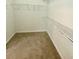 Walk-in closet with carpeted flooring and metal shelving at 2520 Legend Mill Run, Dacula, GA 30019