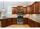 Kitchen featuring granite countertops, stainless steel appliances, hardwood floors, and cherry wood cabinetry at 311 Ridge Hill Cir # 1, Marietta, GA 30064