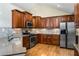Kitchen featuring granite countertops, stainless steel appliances, hardwood floors, and cherry wood cabinetry at 311 Ridge Hill Cir # 1, Marietta, GA 30064