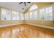 Bright sunroom featuring hardwood floors, multiple windows with white shutters, and a vaulted ceiling at 311 Ridge Hill Cir # 1, Marietta, GA 30064