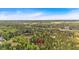 An aerial view of a forest with a red pin location marker under a blue sky at 3800 Macland Rd, Hiram, GA 30141