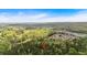 Wide aerial shot of a wooded area with a red pin location marker at 3800 Macland Rd, Hiram, GA 30141