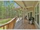 Spacious back porch featuring wood floors, ceiling fans, and a grill for outdoor gatherings at 3800 Macland Rd, Hiram, GA 30141