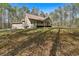 Charming backyard with a spacious grassy area, mature trees, and a serene wooded backdrop at 3800 Macland Rd, Hiram, GA 30141