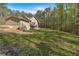Spacious backyard featuring lush green grass and mature trees providing a private and serene outdoor space at 3800 Macland Rd, Hiram, GA 30141