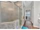 Bathroom features a tiled shower with glass doors, wood look floors, and neutral color palette at 3800 Macland Rd, Hiram, GA 30141