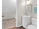 A half bath with a pedestal sink, a mirror with a silver frame, and a toilet are visible at 3800 Macland Rd, Hiram, GA 30141