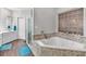 Bathroom features a large soaking tub with tile surround, wood look floors, and separate shower at 3800 Macland Rd, Hiram, GA 30141
