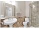Bathroom features a pedestal sink, tiled floors and walls, and a tiled shower with glass door at 3800 Macland Rd, Hiram, GA 30141