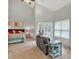 Bright bedroom features a seating area, French doors leading to a deck, and a ceiling fan at 3800 Macland Rd, Hiram, GA 30141