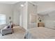 Spacious bedroom featuring a tall ceiling, carpet, a sitting area, and a decorative glass block window at 3800 Macland Rd, Hiram, GA 30141
