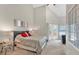 Bright bedroom features a tall ceiling, plush carpet, a comfortable bed, and access to a private balcony at 3800 Macland Rd, Hiram, GA 30141