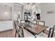 Spacious dining area with modern chandelier, wood floors, and butler's pantry at 3800 Macland Rd, Hiram, GA 30141