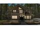Charming two-story home with a balcony, covered porch, mature trees, and exterior lighting at 3800 Macland Rd, Hiram, GA 30141