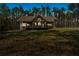 Home exterior at dusk featuring a long covered porch and views of trees in the front yard at 3800 Macland Rd, Hiram, GA 30141