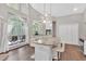 Bright kitchen featuring an island with barstool seating, stainless appliances, and large windows at 3800 Macland Rd, Hiram, GA 30141