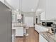 Well-equipped kitchen with modern stainless steel appliances, island with seating, and wood flooring at 3800 Macland Rd, Hiram, GA 30141