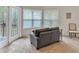 Sitting area includes French doors to the outside, large windows, and a comfortable love seat at 3800 Macland Rd, Hiram, GA 30141