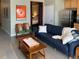 A modern living room with a comfortable couch, movie poster, and a peek into the bedroom through an open doorway at 620 Glen Iris Ne Dr # 401, Atlanta, GA 30308