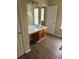 Bathroom featuring a wood vanity with a white countertop, a white sink, and new light fixtures at 6715 Roscommon Dr, Austell, GA 30168