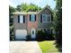 Charming two-story home with a well-maintained lawn and an attached one car garage at 6715 Roscommon Dr, Austell, GA 30168