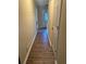 Hallway featuring wood-look flooring, light walls and white baseboards at 6715 Roscommon Dr, Austell, GA 30168
