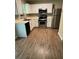 Bright eat-in kitchen featuring stainless steel appliances, white cabinets and a tiled backsplash at 6715 Roscommon Dr, Austell, GA 30168