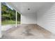 A shaded carport showing a door to backyard and storage at 1070 Kirkland Rd, Covington, GA 30016