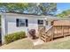 Exterior of home shows a cozy backyard with stairs leading to an elevated wooden patio at 1509 Stone Gate Ln, Atlanta, GA 30317