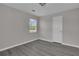 Simple, bright room with modern gray flooring and one window at 1509 Stone Gate Ln, Atlanta, GA 30317