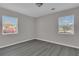 Simple, bright room with modern gray flooring and natural light at 1509 Stone Gate Ln, Atlanta, GA 30317