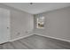 Simple, bright bedroom featuring modern gray flooring and bare walls at 1509 Stone Gate Ln, Atlanta, GA 30317